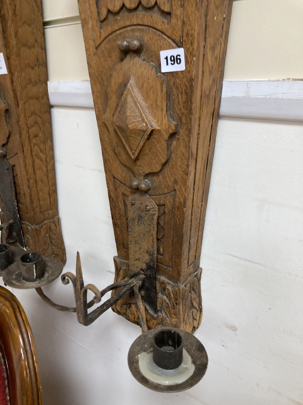 A pair of oak and iron wall sconces, height 88cm